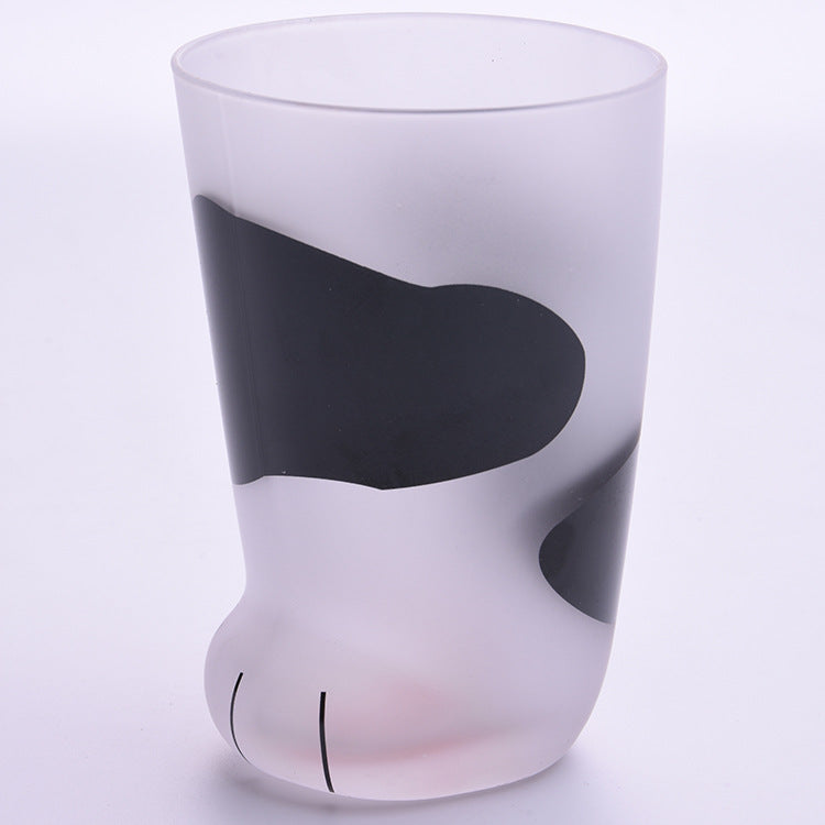 Glass with a cat-shaped design on a light purple background