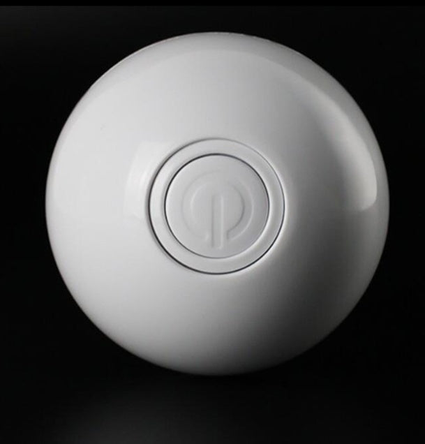 White spherical object with a central logo on a black background