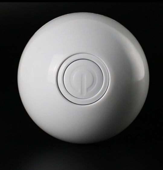 White spherical object with a central logo on a black background