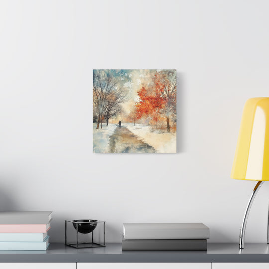Abstract landscape painting on a wall above a desk with books and a lamp.