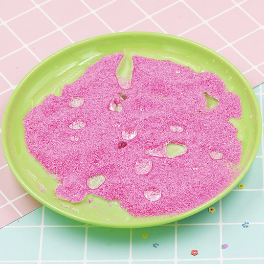 Pink slime on a green plate with a pink and blue checkered background