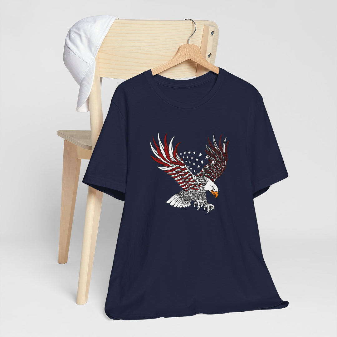 Navy blue t-shirt with an eagle design on a wooden chair against a white background