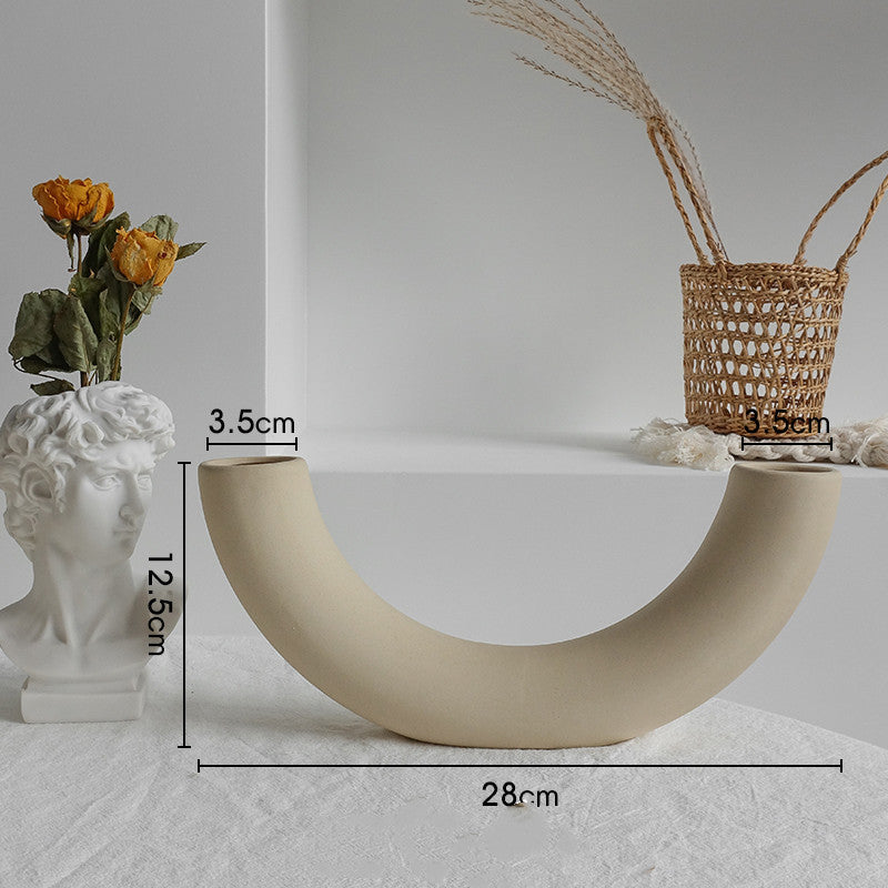 Beige curved decorative piece with measurements on a neutral background