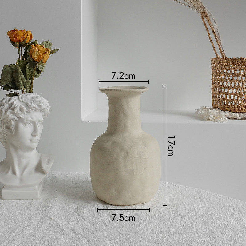 Beige textured vase with measurements on a white surface