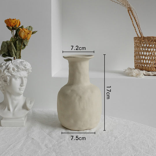 Beige textured vase with measurements on a white surface