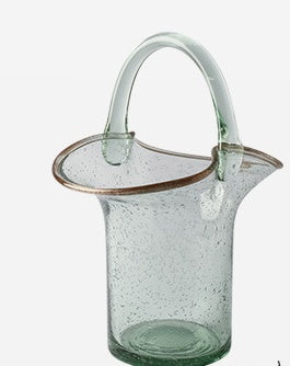Clear glass pitcher with a handle on a white background