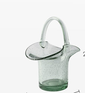 Clear glass teapot with a handle on a white background