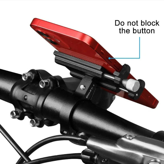 Red phone mount on a motorcycle handlebar with text indicating not to block the button.