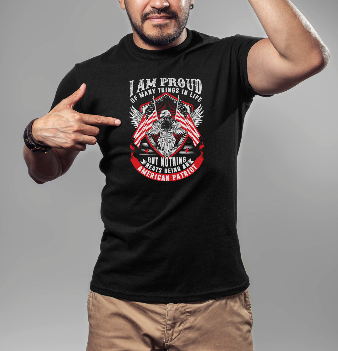 Man wearing a black t-shirt with an eagle and American flag design, pointing to the text.