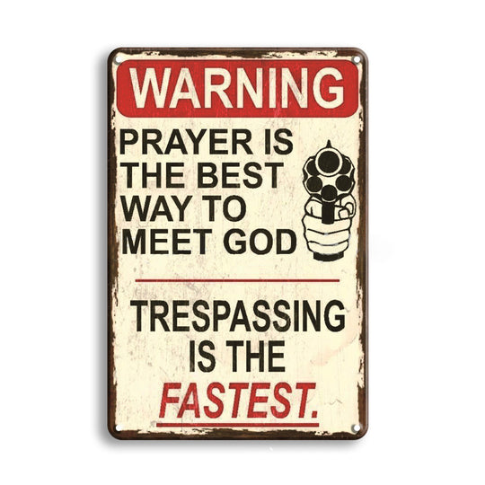 Vintage-style metal sign with humorous text about prayer and gun violence.