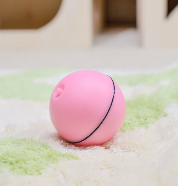 Pink ball with a black string on a textured surface