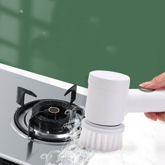 Cleaning brush with water being used on a gas stove