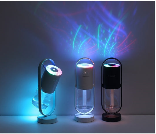 Three colorful light projectors on a dark background