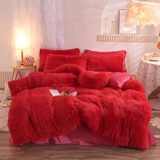 Red fluffy comforter set on a bed in a bedroom setting