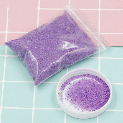 Purple bath salts in a clear bag and white container on a checkered background