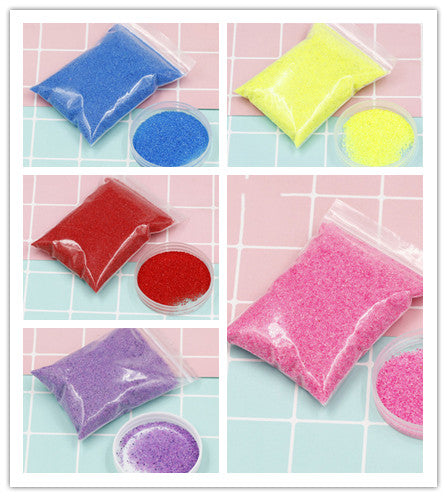 Colorful packets of bath bombs on a tiled bathroom floor.