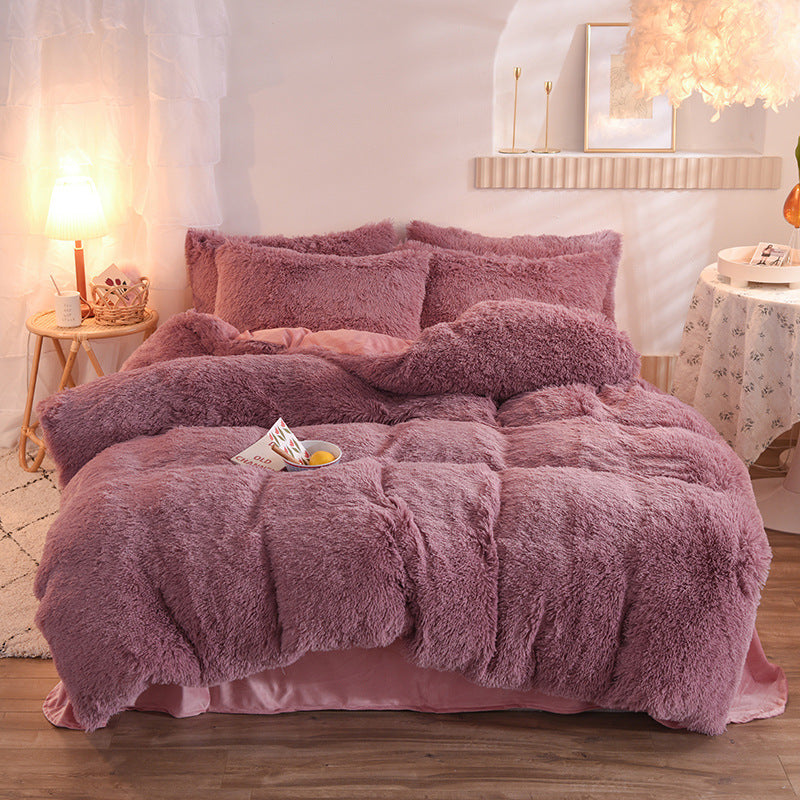 Pink fluffy bedding set on a bed in a cozy bedroom.