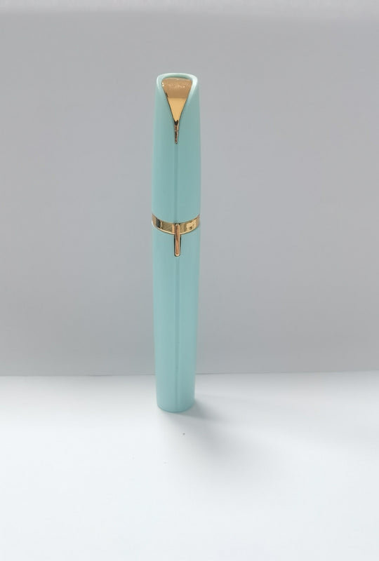 Light blue pen with gold accents on a white background