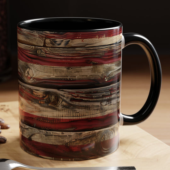 Decorative mug with a coffee-themed design on a wooden surface with coffee beans and a cookie.