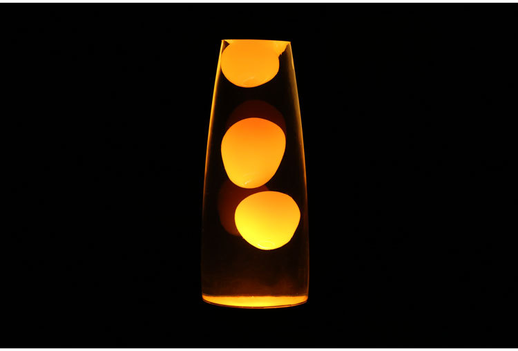 Vase-shaped lava lamp with glowing yellow liquid on a black background