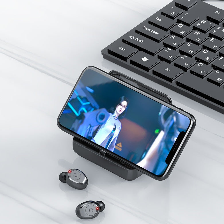 Smartphone with a keyboard and earbuds on a light surface