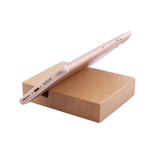 Smartphone on a wooden stand with a white background