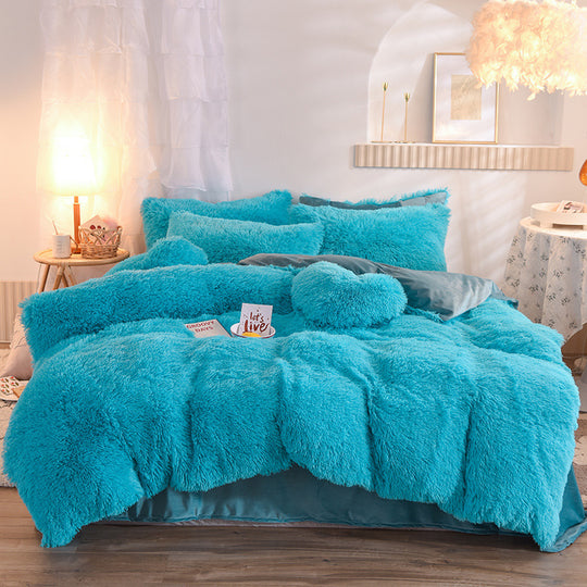 Turquoise fluffy comforter set on a bed in a bedroom setting