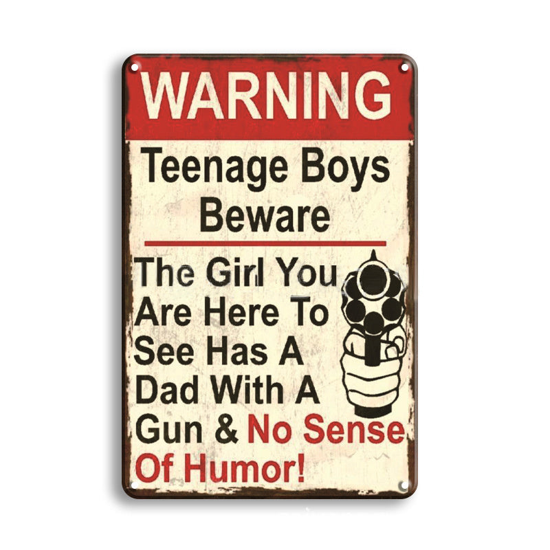 Vintage-style metal sign with humorous warning text about teenage boys and a girl with a gun.