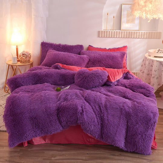 Purple fluffy comforter set on a bed in a bedroom setting.