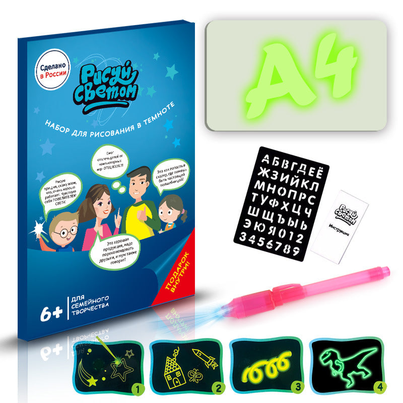 Dark board with glow-in-the-dark drawings, pen, and packaging on a white background