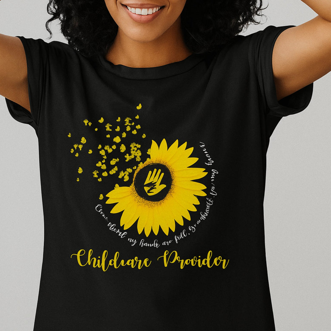 Person wearing a black t-shirt with a yellow sunflower design and text on a gray background