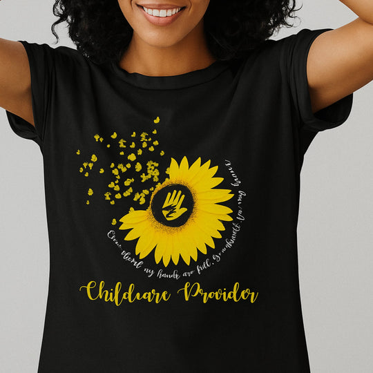 Person wearing a black t-shirt with a yellow sunflower design and text on a gray background