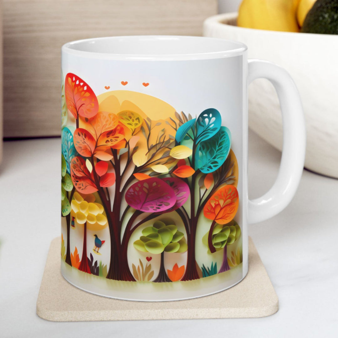 White mug with colorful tree design on a white surface