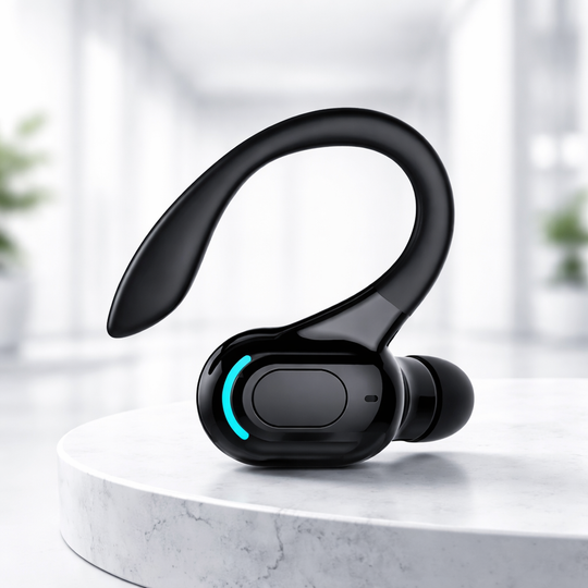 Black wireless earbud headset on a white surface with a blurred background