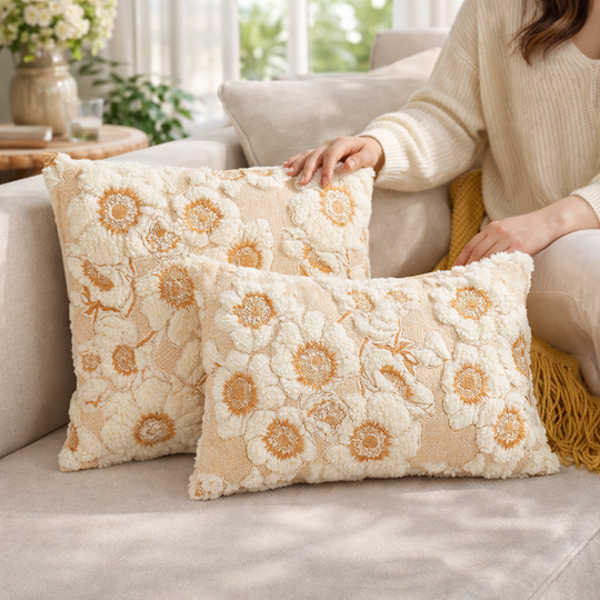 Decorative pillows with floral pattern on a couch in a living room setting