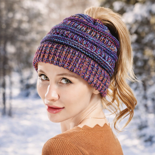 Woman wearing colorful knit ponytail beanie in winter setting