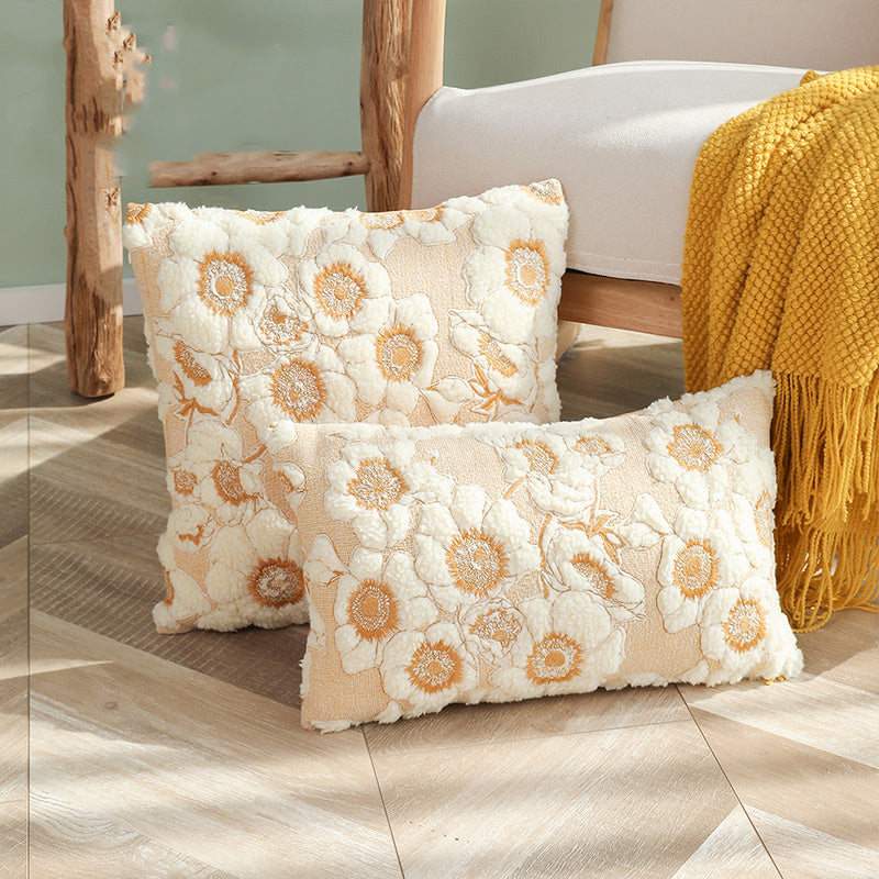 Decorative pillows with floral pattern on a wooden floor