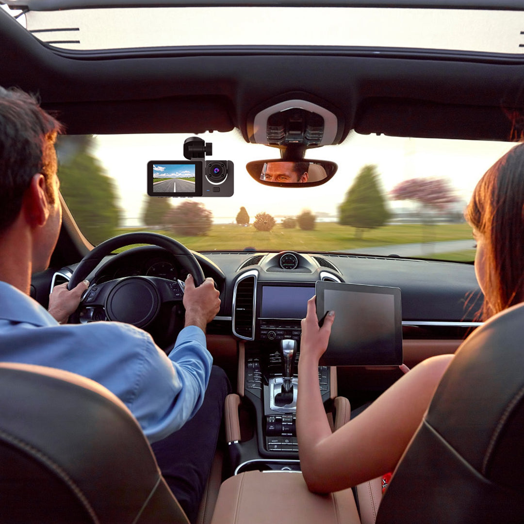 Two people inside a car with a dashboard camera recording their journey.