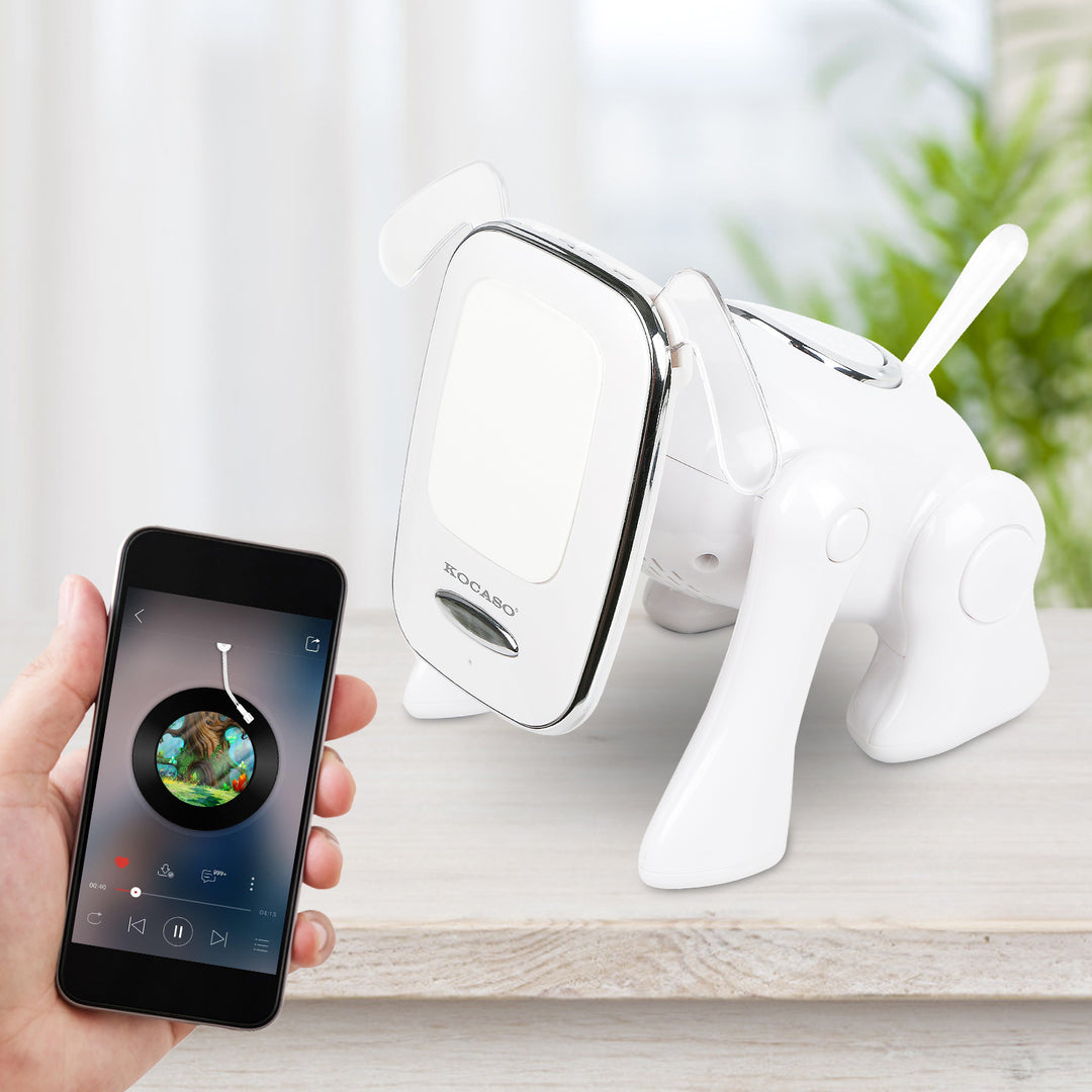 White elephant-shaped speaker with smartphone displaying music app on a light surface.