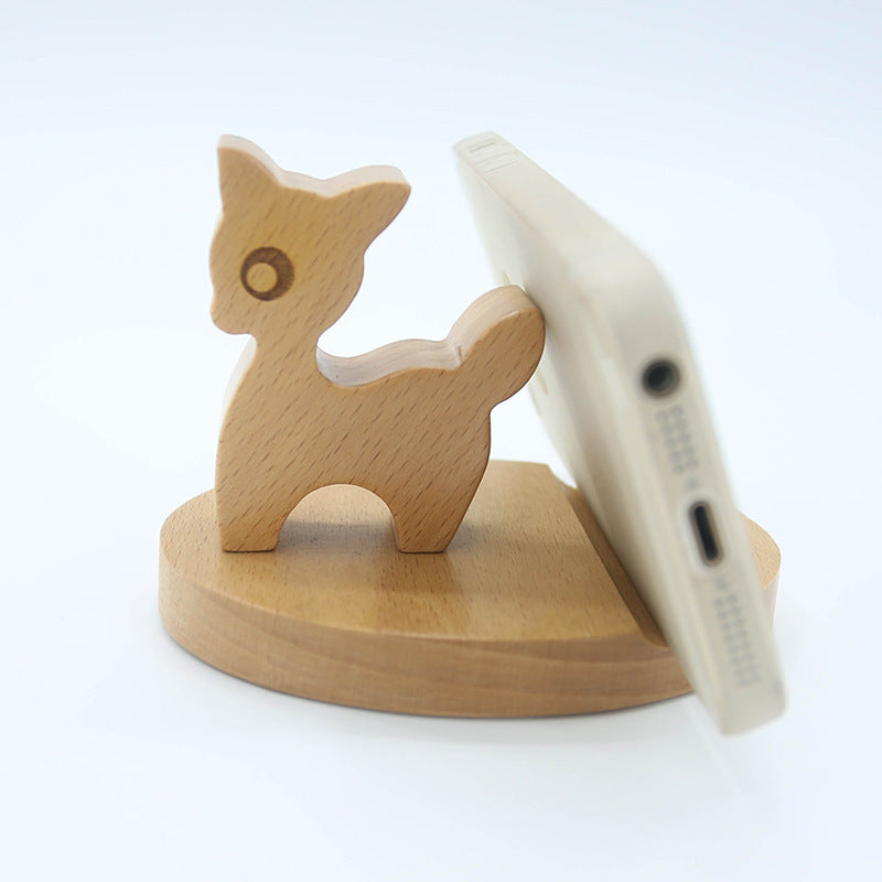 Wooden phone stand with a cat design holding a phone on a white background