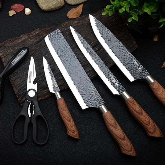Set of knives with wooden handles on a dark surface