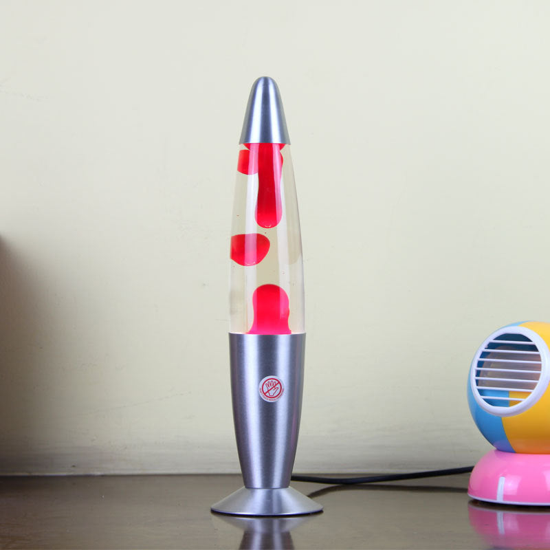 Lava lamp with red liquid and silver base on a plain background