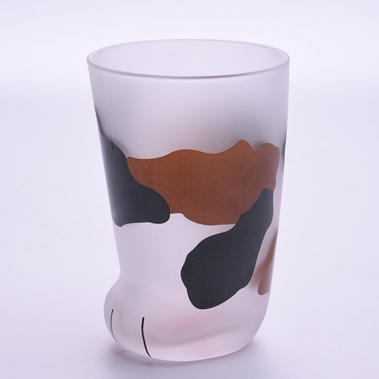 Glass with a cow design on a light purple background