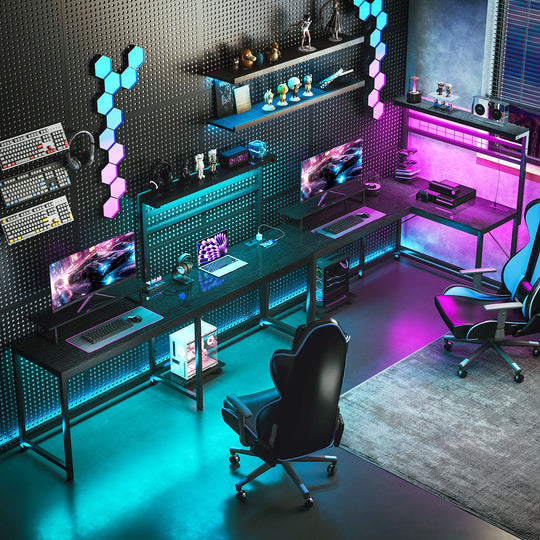 Modern gaming room with multiple monitors, gaming chairs, and colorful LED lights.