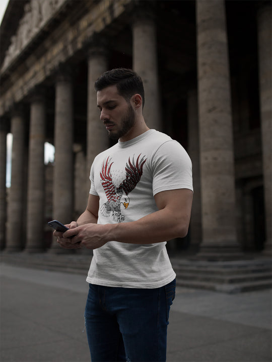Man wearing a white t-shirt with an eagle design, standing in front of classical architecture.