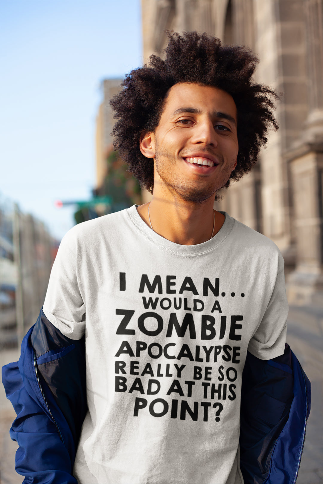 Person wearing a t-shirt with a humorous zombie apocalypse joke in an urban setting